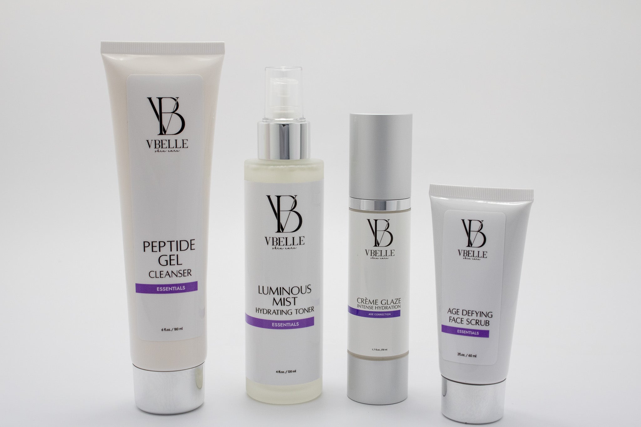 tube of peptide gel cleanser next to a bottle of luminous mist toner next to a bottle of creme glaze next to a tube of age defying face scrub