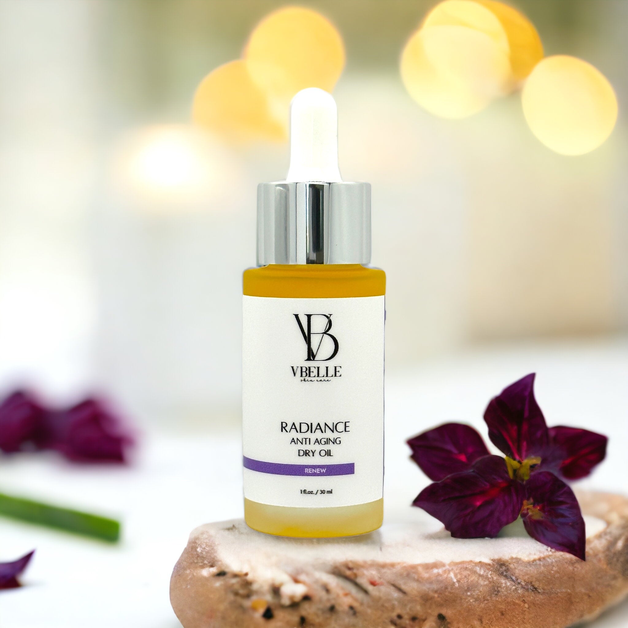 a bottle of Radiance dry oil with flowers in the background