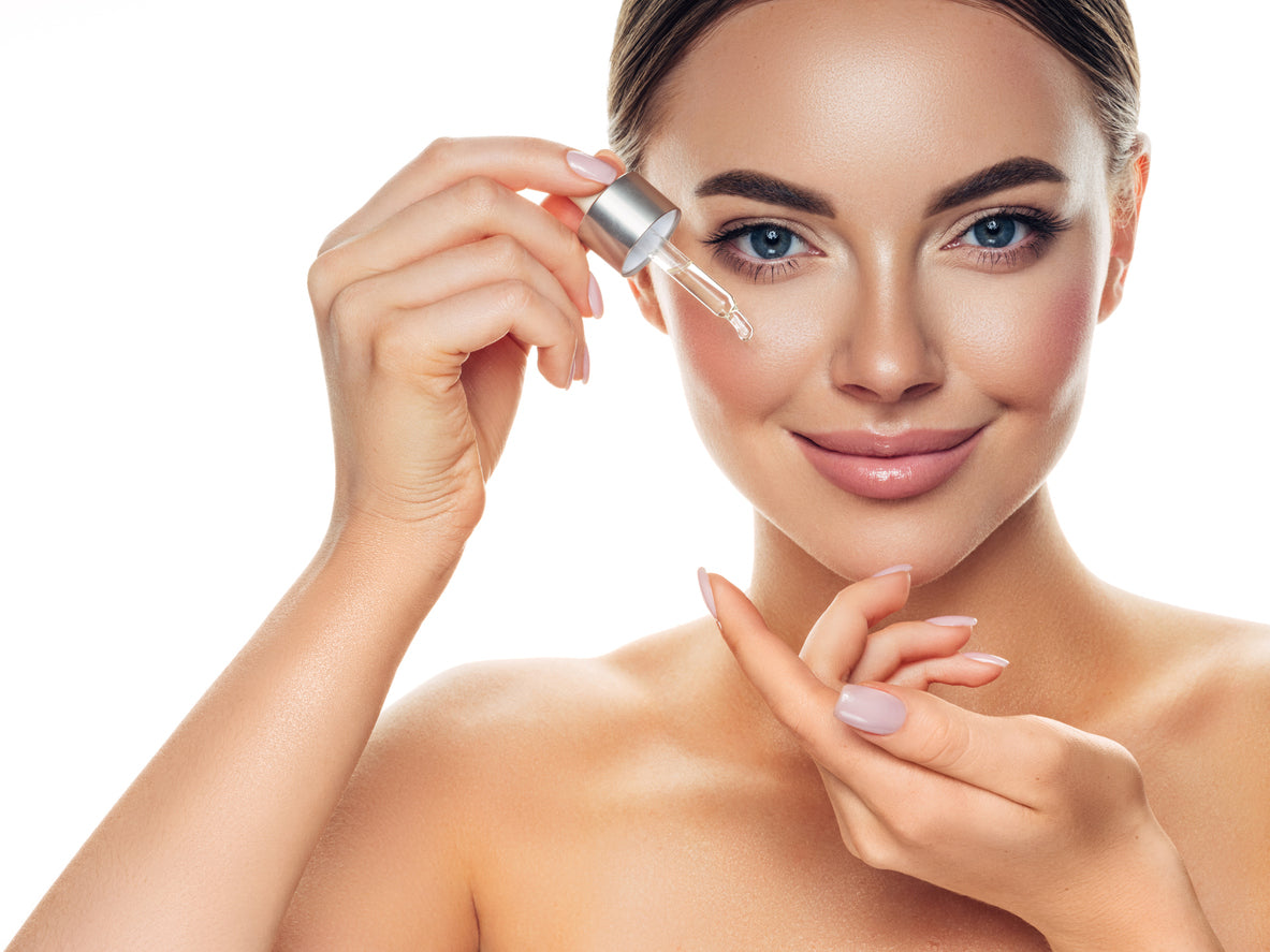 female model applying vitality vitamin c-20 serum onto face