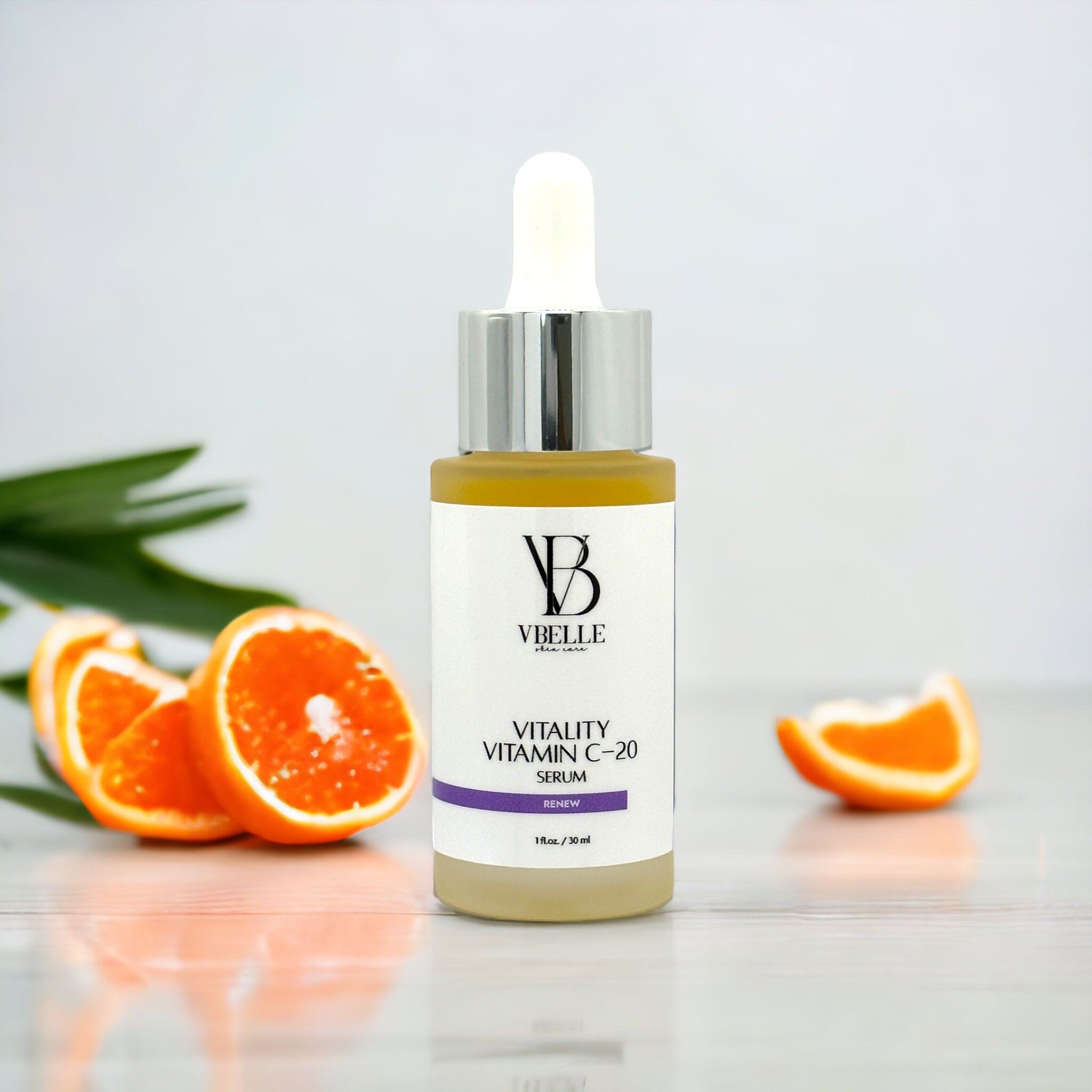 a bottle of Vitality Vitamin C-20 on a white background with oranges