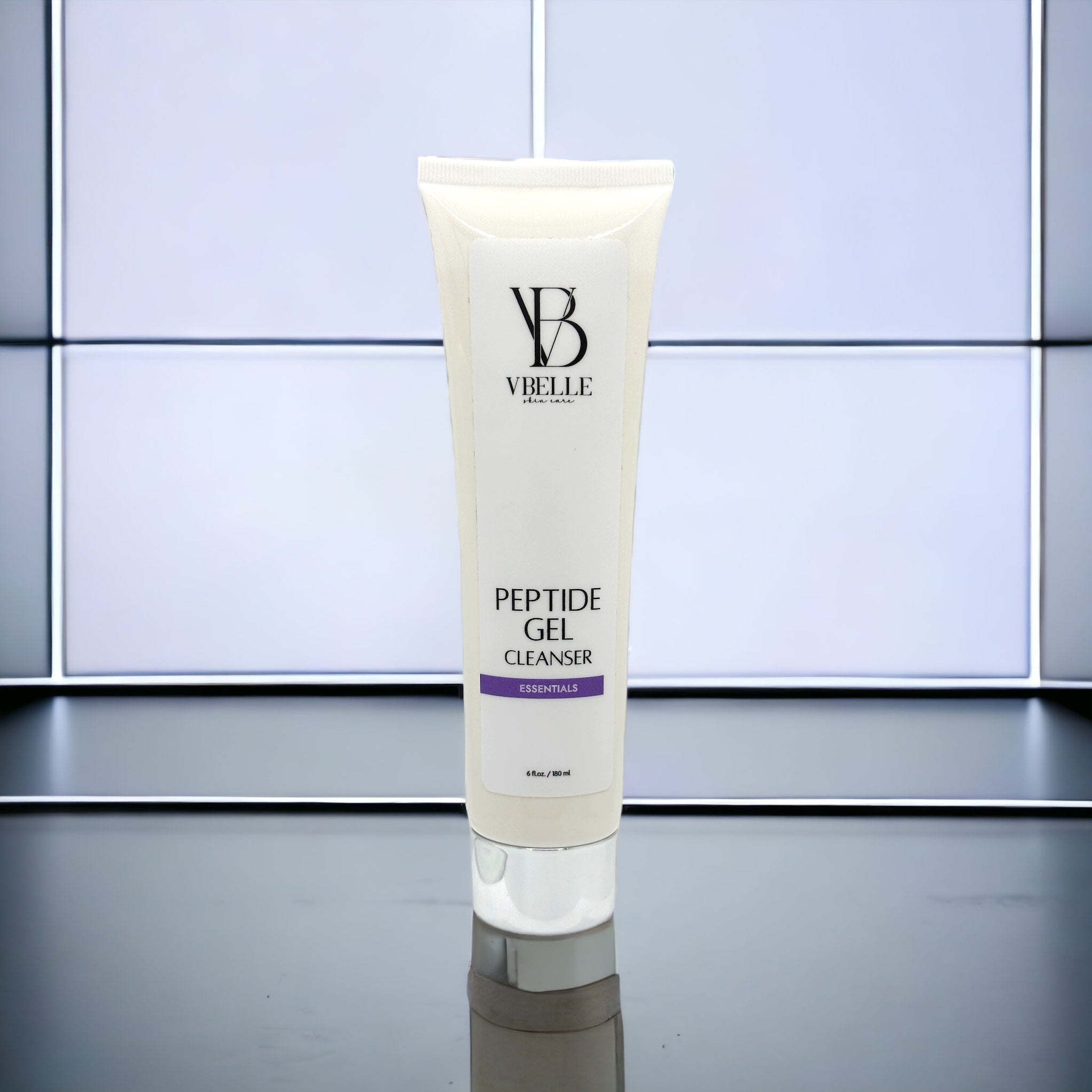 tube of peptide gel cleanser on a reflective bathroom counter and tile