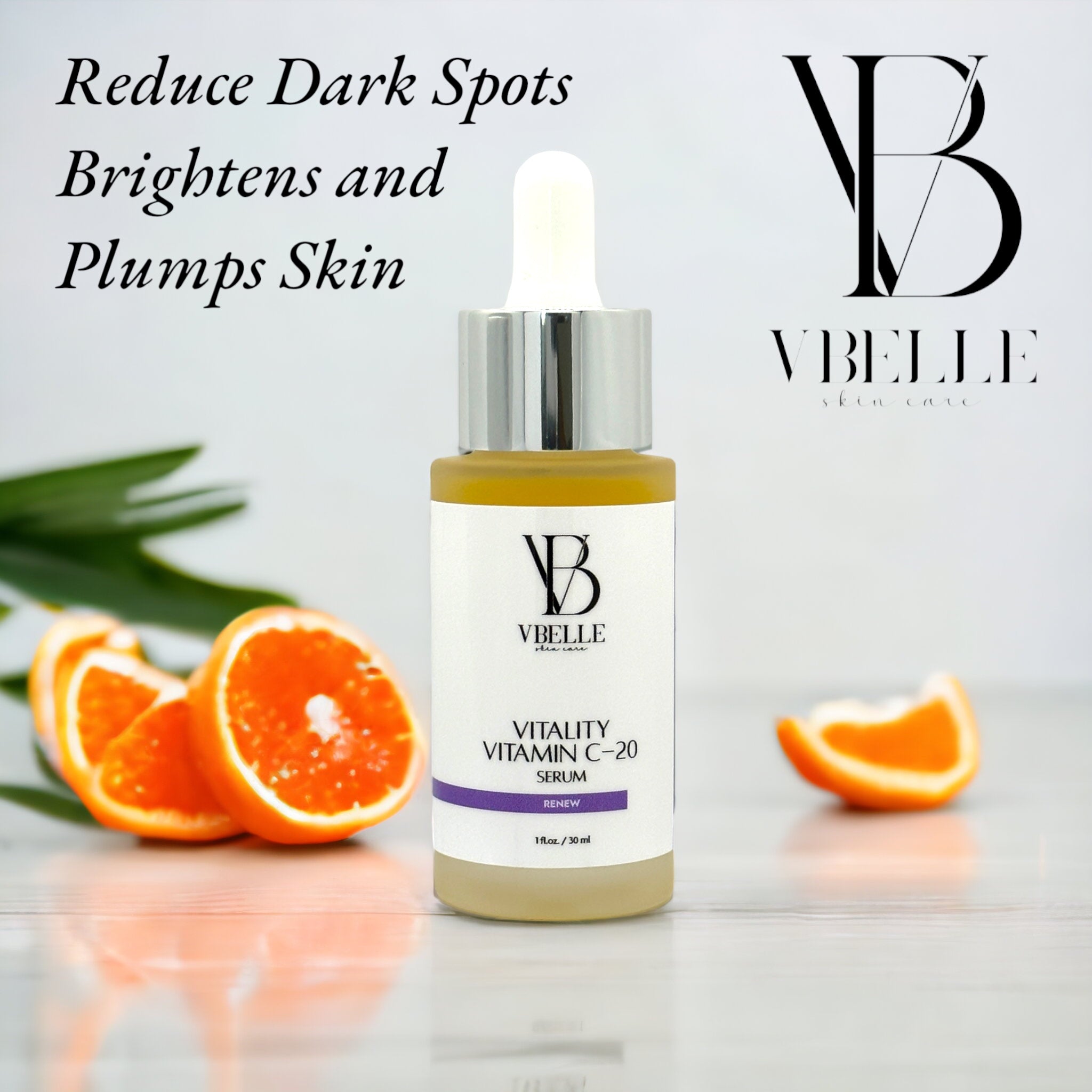 a bottle of vitality vitamin c-20 serum on a reflective surface and oranges in the background